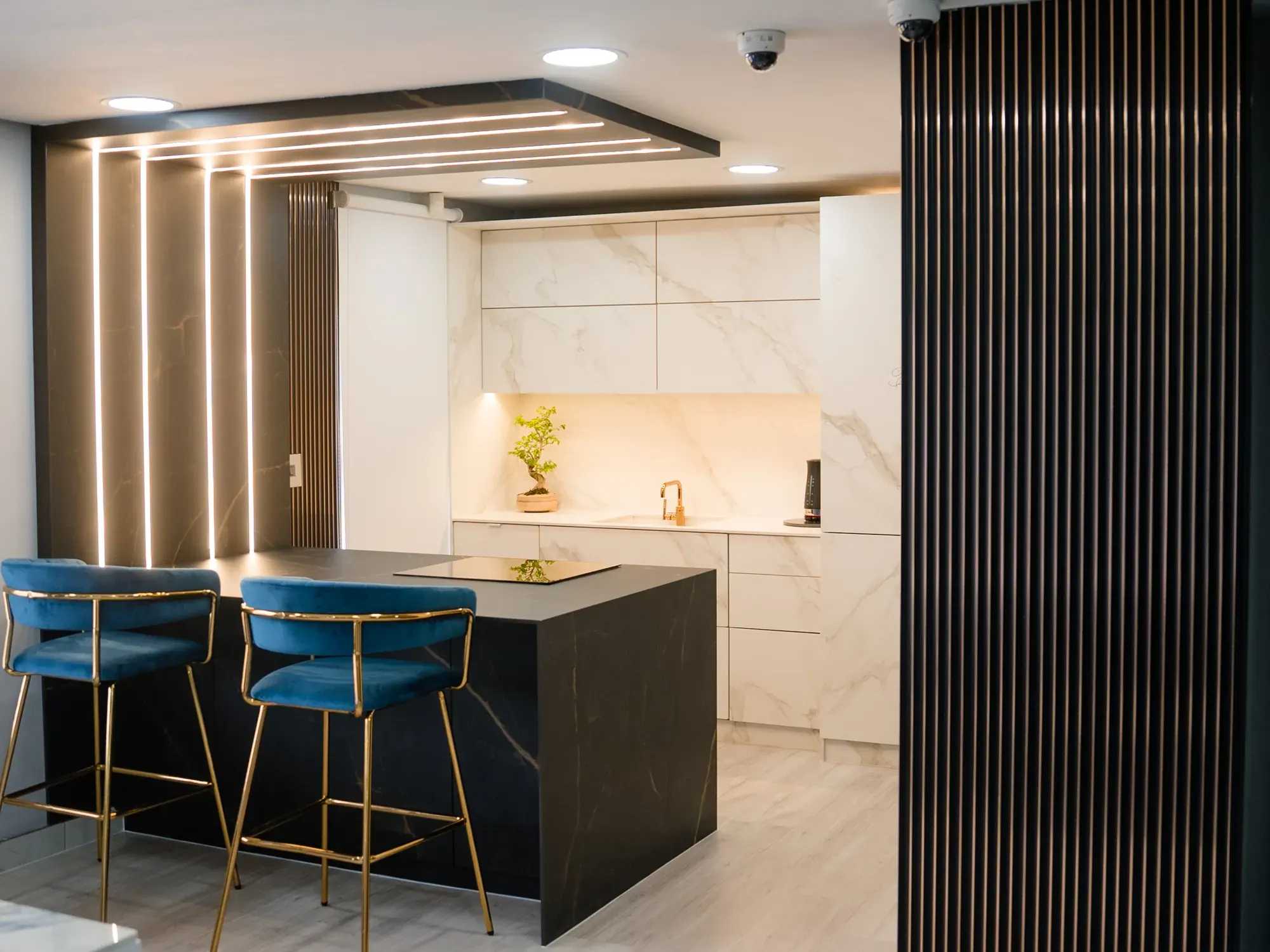 Completed kitchen, island and stone-lined wall.