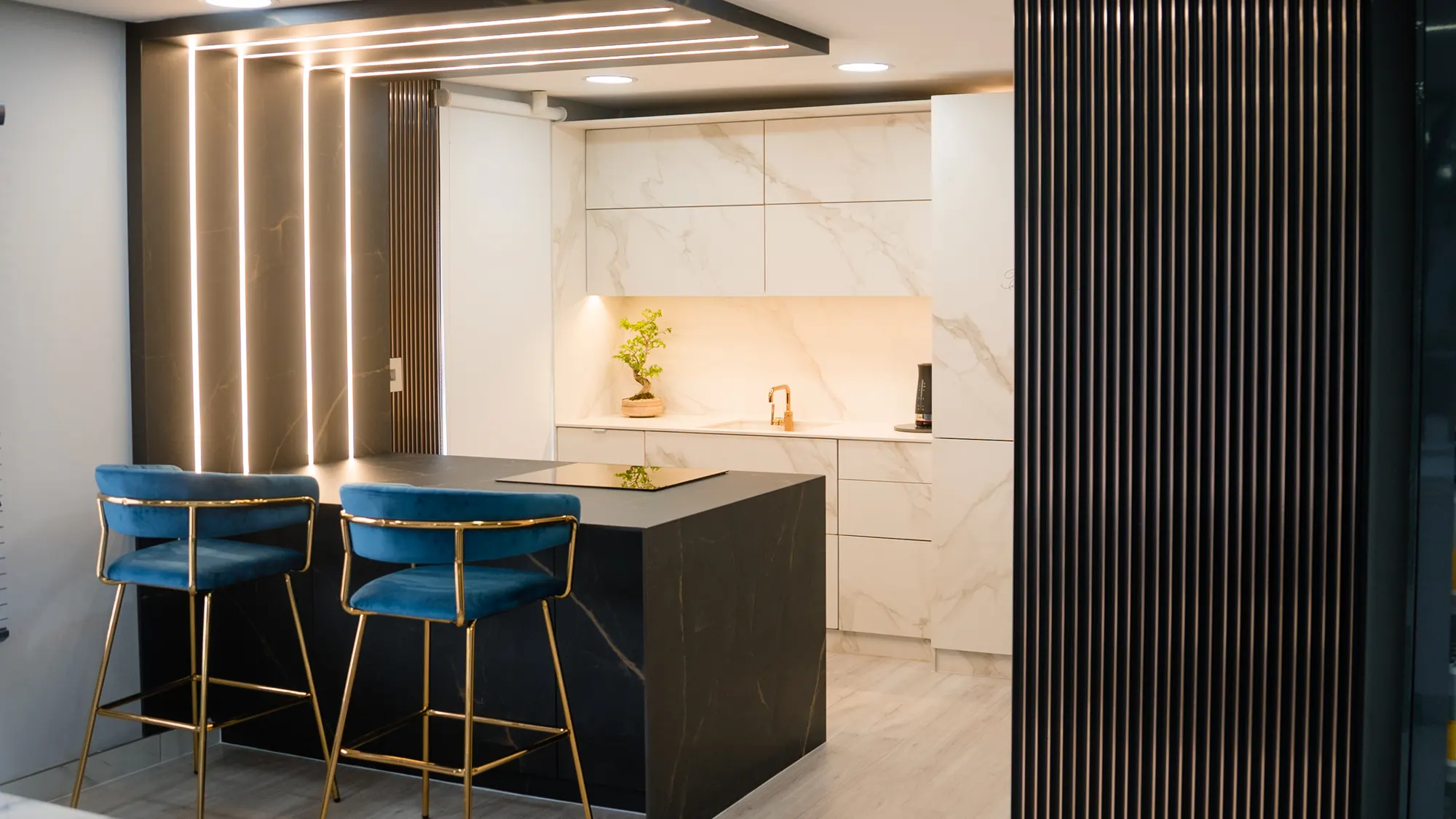 Completed kitchen, island and stone-lined wall.