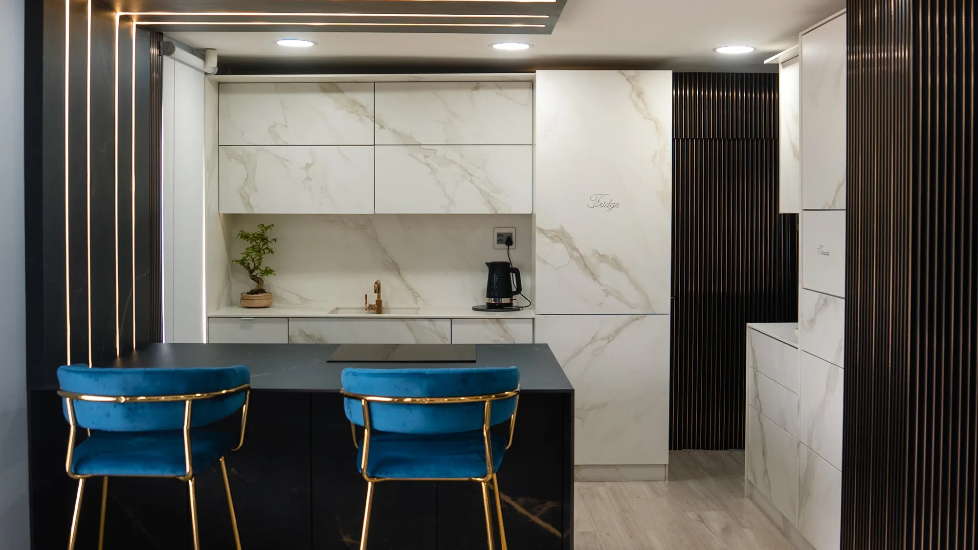 Completed kitchen with marble-effect walls and island.