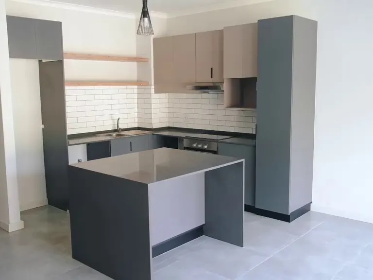 Grey kitchen with stone island and waterfall end.