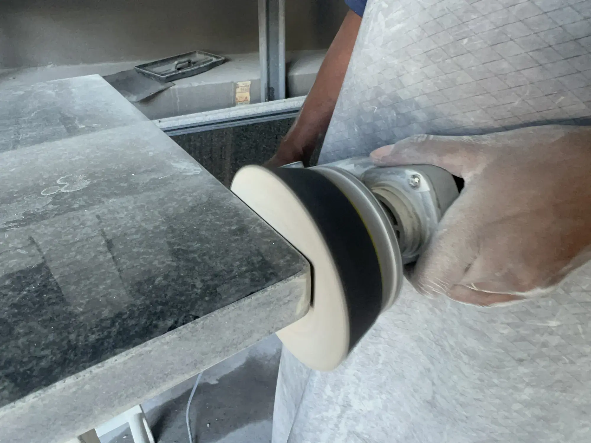 Hand polishing a stone edge.