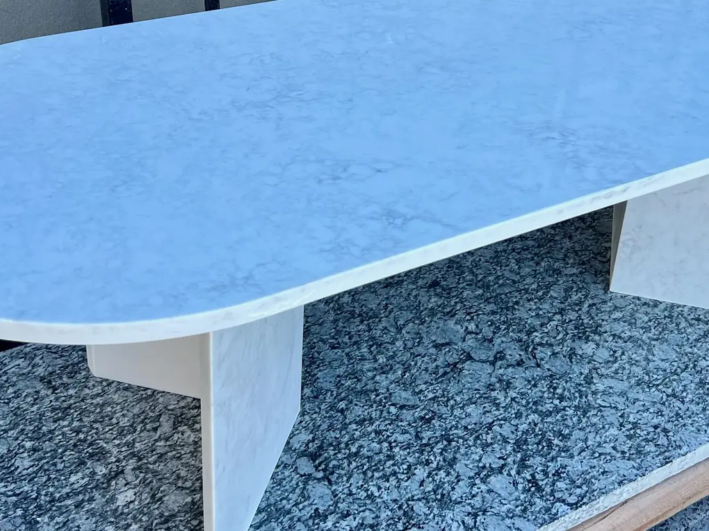 Oval stone table on two supporting legs.