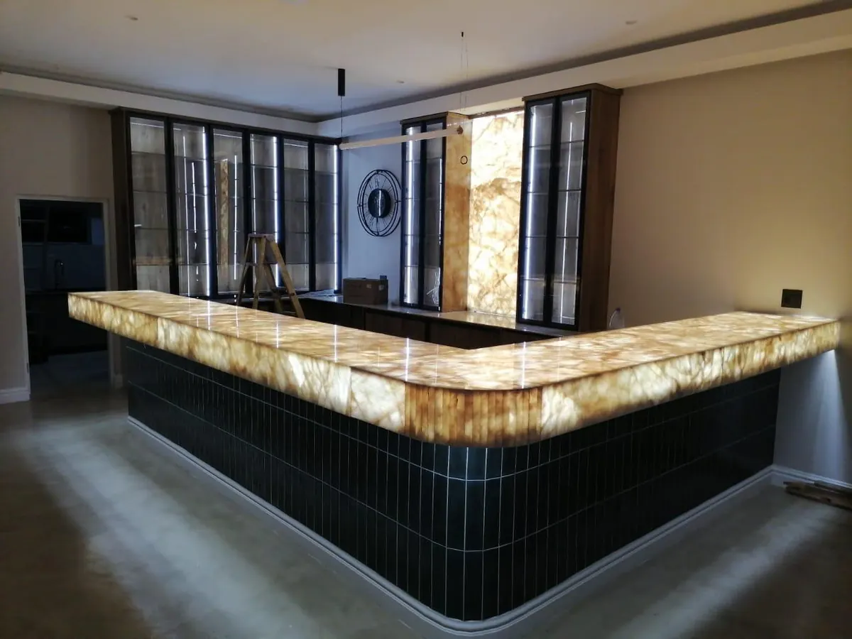 L-shaped illuminated bar and matching wall panel.