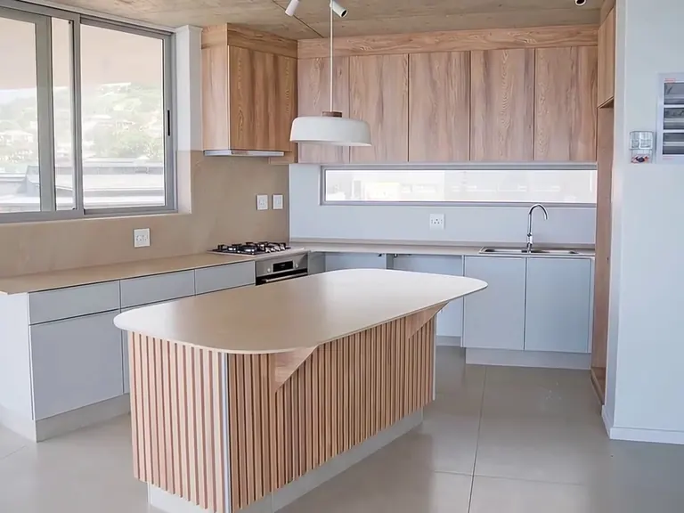 Pale stone kitchen island in an apartment.
