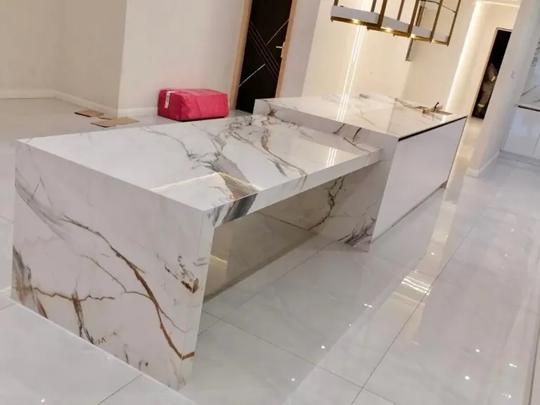 White stone waterfall island in a kitchen.