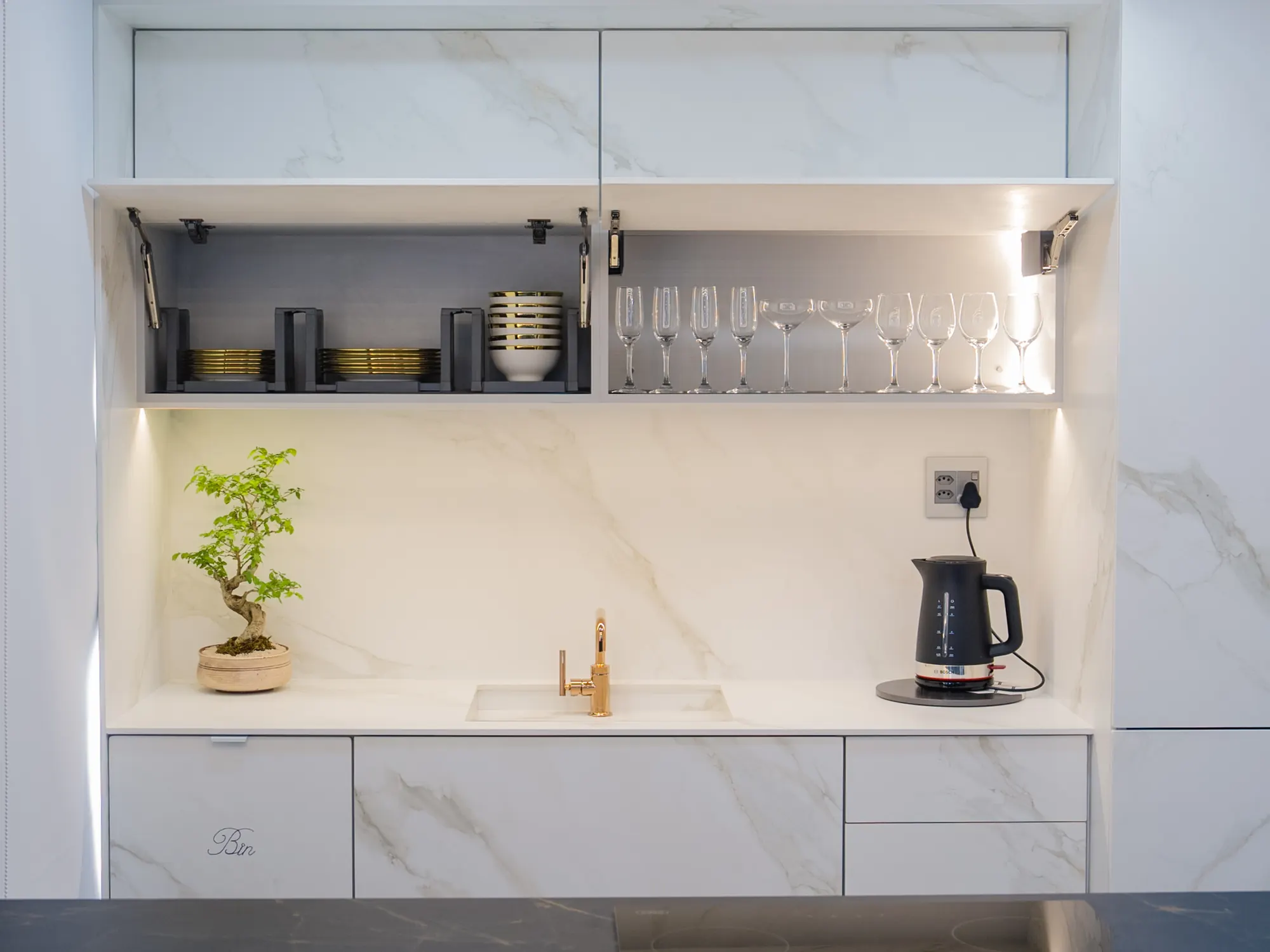 Stone-faced cabinet fronts and matching worktop.
