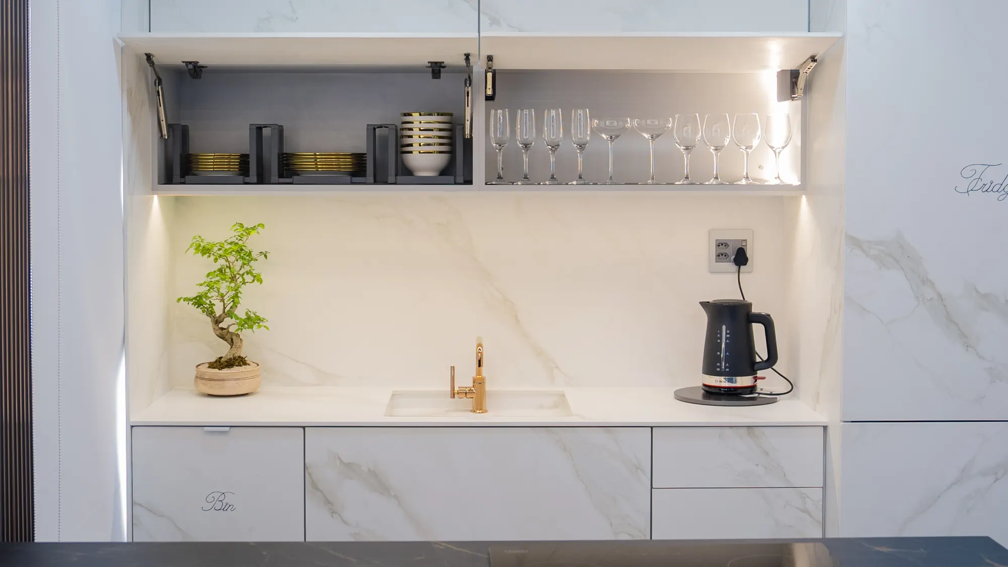 Stone-faced cabinet fronts and matching worktop.
