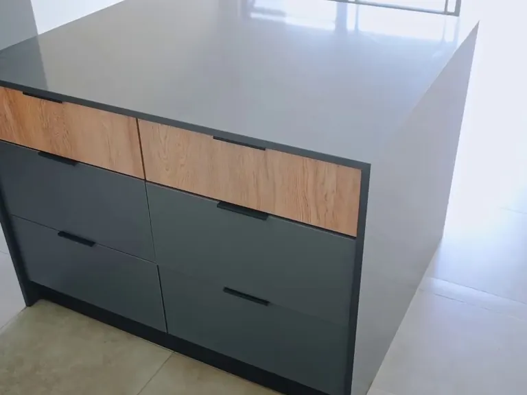 Stone island top above timber drawers.