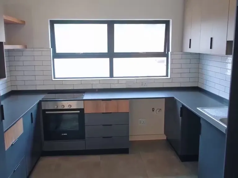 U-shaped kitchen with stone worktops.