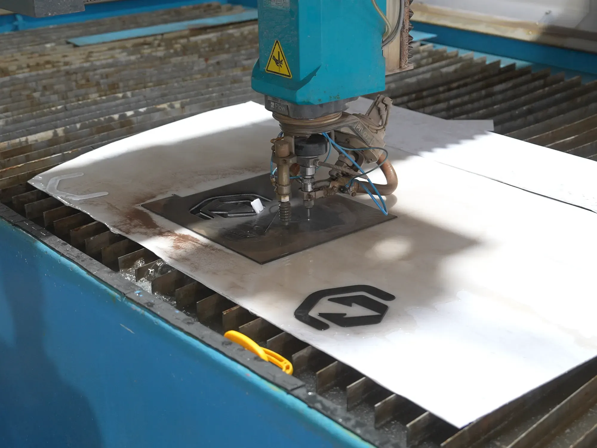 Waterjet machine and slab in workshop.